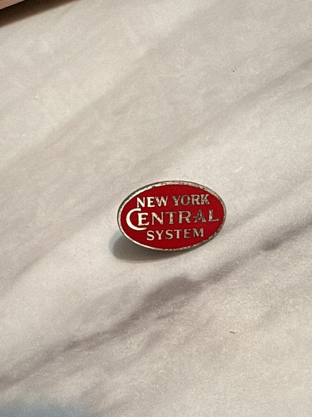 Vintage New York Central System Railroad Pin

Oval red enamel lapel pin reading